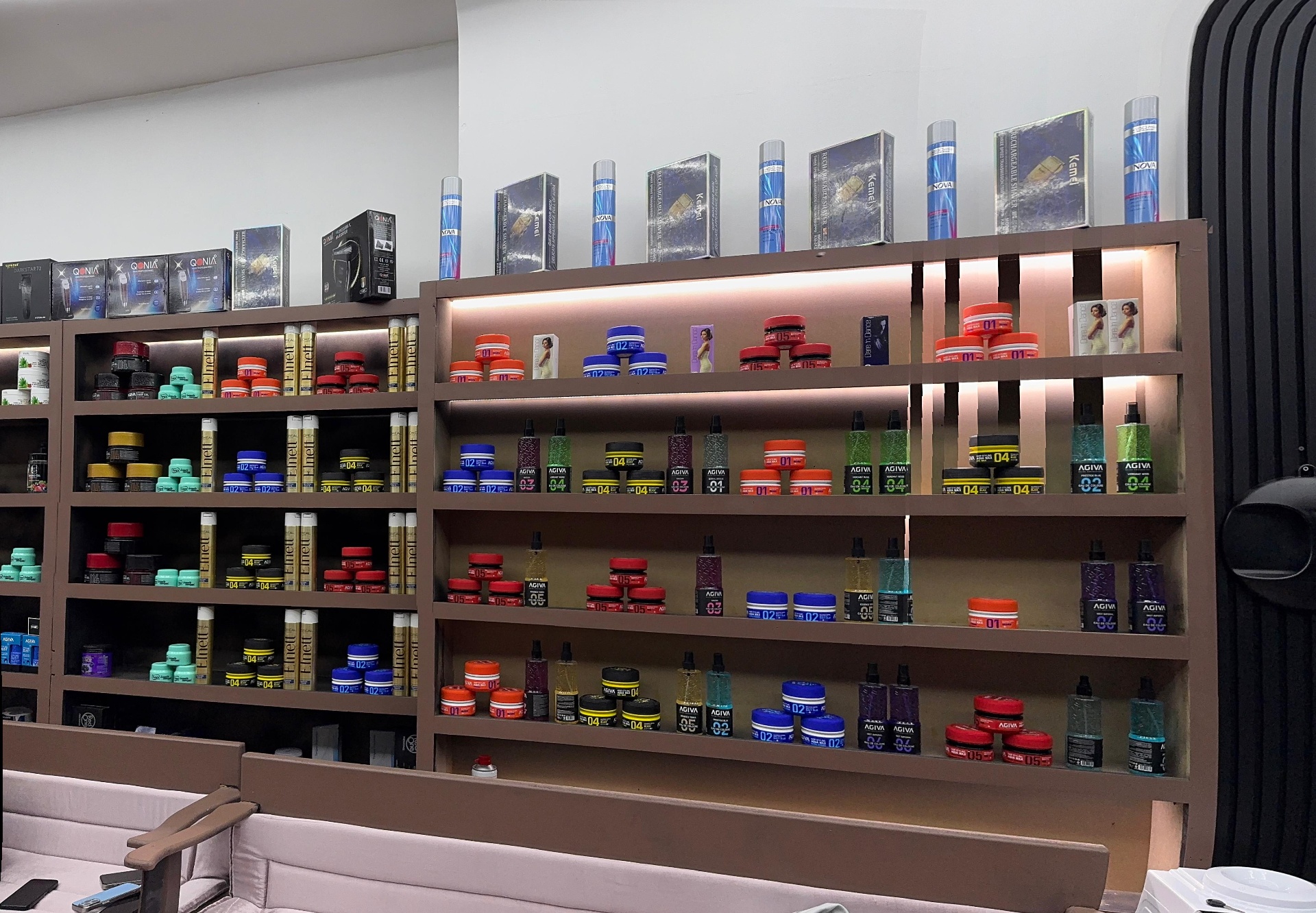 Hair products and clippers on the shelf at Zoya Glam